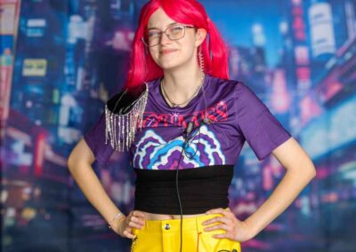 staff member with pink hair dressed and ready for ACECON